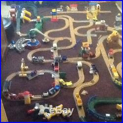 Geotrax train set with tracks, bridges, buildings, engines, cars, and remote